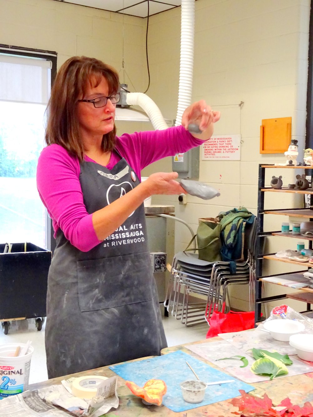 Art Instructor Corina teaching seniors how to make clay leaves photo by I Lee, October 6, 2015