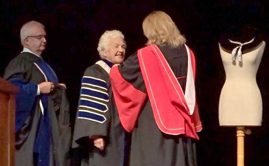 Dr. Mary Preece puts Chancellor's robe on Hazel McCallion