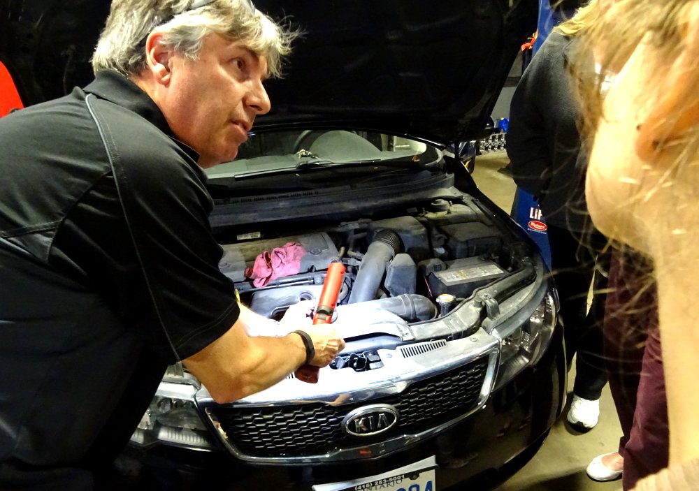 Sean Devine of Maxwell Auto Inc. explains auto parts and functions. Photo by I Lee, 11 May 2016